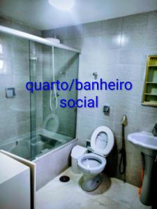 a bathroom with a toilet and a shower and a sink at Casa Dna Nair Gus in Ubatuba