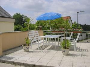 a table and two chairs and an umbrella on a roof at Holiday apartment in Ramsberg +5 photos