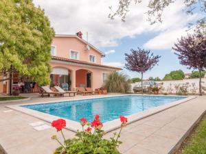 a villa with a swimming pool and a house at Villa in Pula 42 with swimming pool in Peroj