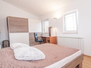 a bedroom with a bed with a desk and a chair at Villa in Pula 42 with swimming pool in Peroj +13 photos