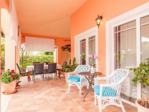 a porch with chairs and a table and a dining room at Villa in Pula 42 with swimming pool in Peroj