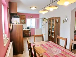 a kitchen and dining room with a table and a refrigerator at Villa in Pula 42 with swimming pool in Peroj