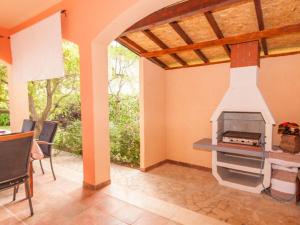a patio with an outdoor fireplace in a house at Villa in Pula 42 with swimming pool in Peroj
