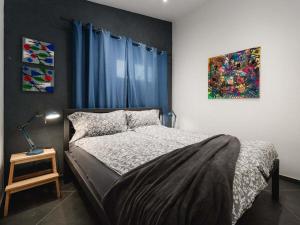 a bedroom with a bed and a painting on the wall at Apartment Urban Black in Poreč