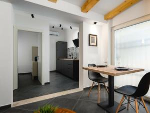 a kitchen and dining room with a table and chairs at Apartment Urban Black in Poreč +12 photos