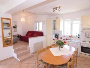 a kitchen and a dining room with a table and a couch at Holiday apartment in Porec with swimming pool in Poreč