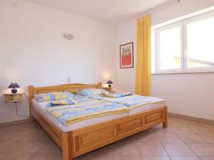 a bedroom with a wooden bed with a window at Holiday apartment in Porec with swimming pool in Poreč