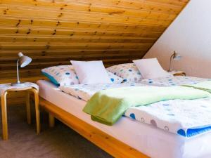 two twin beds in a room with a wooden ceiling at Holiday home with 2 bedrooms in Burggaillenreuth