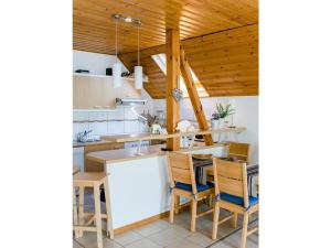 a kitchen with wooden ceilings and a table and chairs at Holiday home with 2 bedrooms in Burggaillenreuth