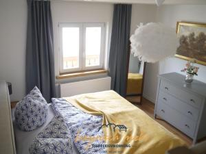 a bedroom with a bed and a window at Bavarian holiday apartment more in Gstadt am Chiemsee
