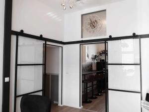 a room with glass doors and a clock on the wall at Holiday apartment with 4 bedrooms in Eisenach +18 photos