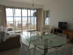 a living room with a glass table and chairs at Apartment Splendid Azur in Sainte-Maxime