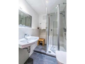 a bathroom with a sink and a shower at One-bedroom apartment in Kalzhofen +12 photos