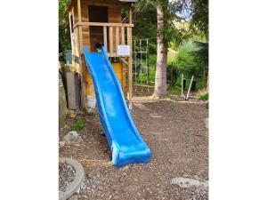 a blue slide in front of a house at Holzer Feng Shui in Rettenberg