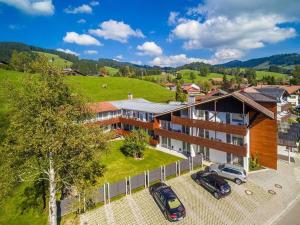 an aerial view of a house with two cars parked in a parking lot at One-bedroom apartment in Kalzhofen