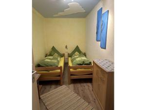 a small room with two beds in a room at Holzer Feng Shui in Rettenberg