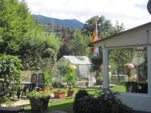 a garden with a table and chairs and plants at Holzer Feng Shui in Rettenberg