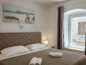 a bedroom with a bed with two towels on it at Deluxe Apartment Antonija in Poreč