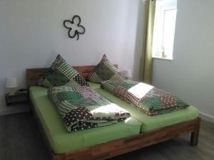 a green couch with pillows on it in a room at One-bedroom apartment in Cobbenrode
