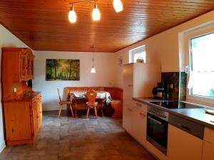 a kitchen with a table and a dining room at One-bedroom apartment in Cobbenrode