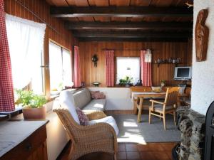 a living room with a couch and a table at 1-bedroom holiday home in Ludwigsthal
