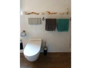 a bathroom with a white toilet and towels at in Fischers Hus in Stenderup +27 photos