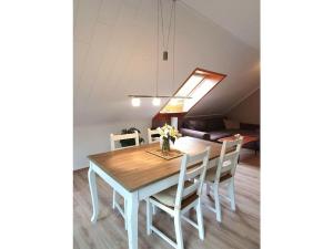 a dining room table and chairs in a room at in Fischers Hus in Stenderup