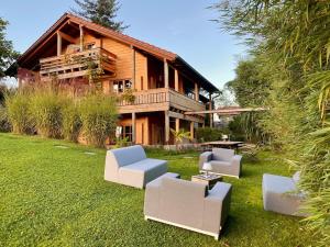 a house with a yard with couches in front of it at Experience luxury in Mollenberg in Mollenberg