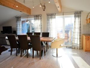 a dining room with a wooden table and chairs at Holiday apartment with 2 bedrooms in Vorderburg
