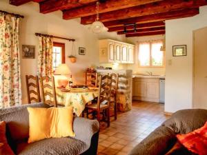 a living room with a table and a kitchen at in southern France La Bastide in Saint-Julien-de-Peyrolas
