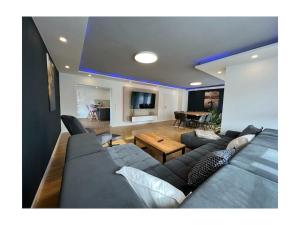 a living room with a large couch and a table at Holiday home with 2 bedrooms in Schopfloch