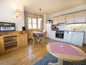 a kitchen with a table and a dining room at Sun meadow sauna, dogs allowed in Balderschwang