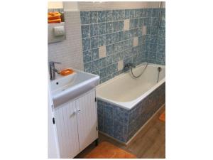 a bathroom with a tub and a sink and a bath tub at Holiday apartment with 2 bedrooms in Hohenfelde