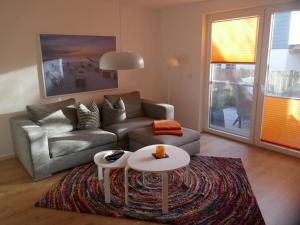 a living room with a couch and a table at Holiday apartment with 2 bedrooms in Hohenfelde