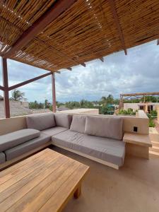 a living room with a couch and a wooden table at Casa Xaviera in Puerto Escondido