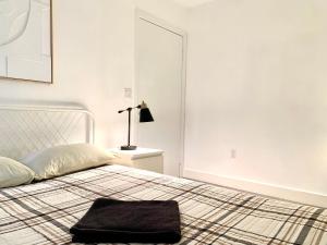 a white bedroom with a bed with a pillow on it at Western Marathon in Los Angeles
