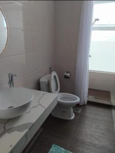 a white bathroom with a sink and a toilet at Menglait Vista Brunei 1 in Bandar Seri Begawan +6 photos