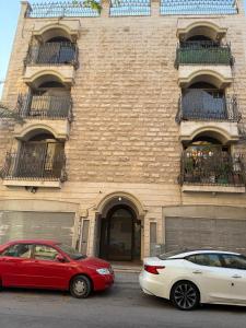 アル・コバールにあるالخبر الشمالية 2のレンガ造りの建物の前に停められた車両2台