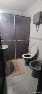 a bathroom with a toilet and a bidet and a sink at A pasitos del mar in La Coronilla +19 photos