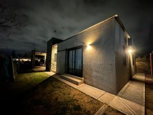 a house with a light on the side of it at night at Rincón de Chacras de Coria in Ciudad Lujan de Cuyo