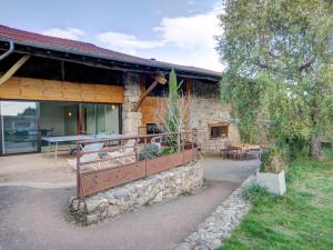 a building with a picnic table on the outside of it at Gîte paisible avec piscine intérieure et animaux acceptés - FR-1-496-132 in Saint-Priest-la-Prugne