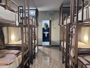a room with several bunk beds and a sink at Chato Hostel in Pakse