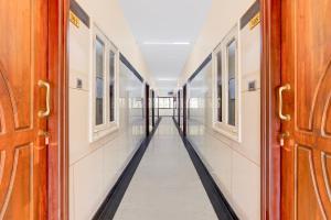an empty corridor in a building with doors open at Super Collection O Vellore Near CMC Hospital Formerly Geetha Residency in Vellore