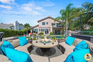 a patio with a fire pit in front of a house at The Palms at Casa Solara in San Diego