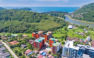 an aerial view of a city with a river and buildings at Naiharn Pearl Condo Hotel by VillaCarte in Nai Harn Beach