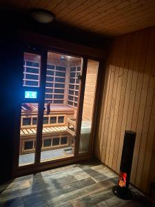 a room with a window with a view of a building at Chalet 87 Engelberg, Cosy Chalet with Superb Views in Engelberg