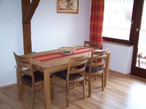 a dining room table with chairs and a bowl on it at Holiday apartment with 2 bedrooms in Eggenthal