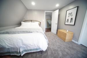 a bedroom with a large bed with a white bedspread at Luxurious Renovated Gem in Convenient Location! in Delta