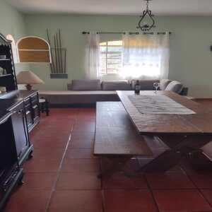 a living room with a table and a couch at WJL Sitio Silva in Ibiúna