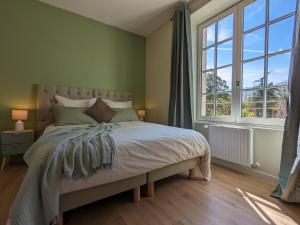 a bedroom with a bed and a large window at Grande maison familiale avec piscine chauffée, wifi et parking à Pranzac - FR-1-653-284 in Pranzac +27 photos